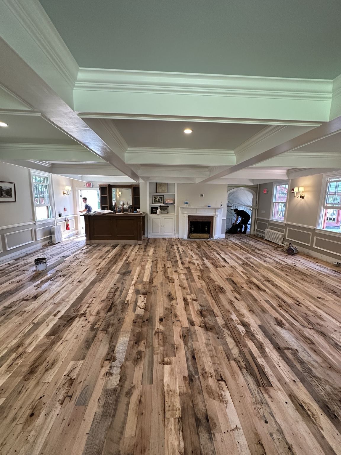 Wood floor with strongly varied board tones, photographed during on-site work