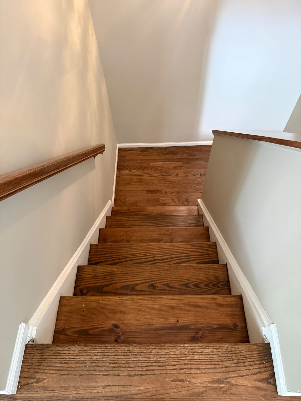 Finished staircase with stained wood treads and white risers